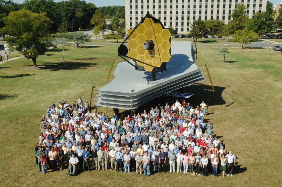 Some of the JWST team members outside a full-scale model of the telescope at Goddard Space Flight Center. Photo Credit: NASA