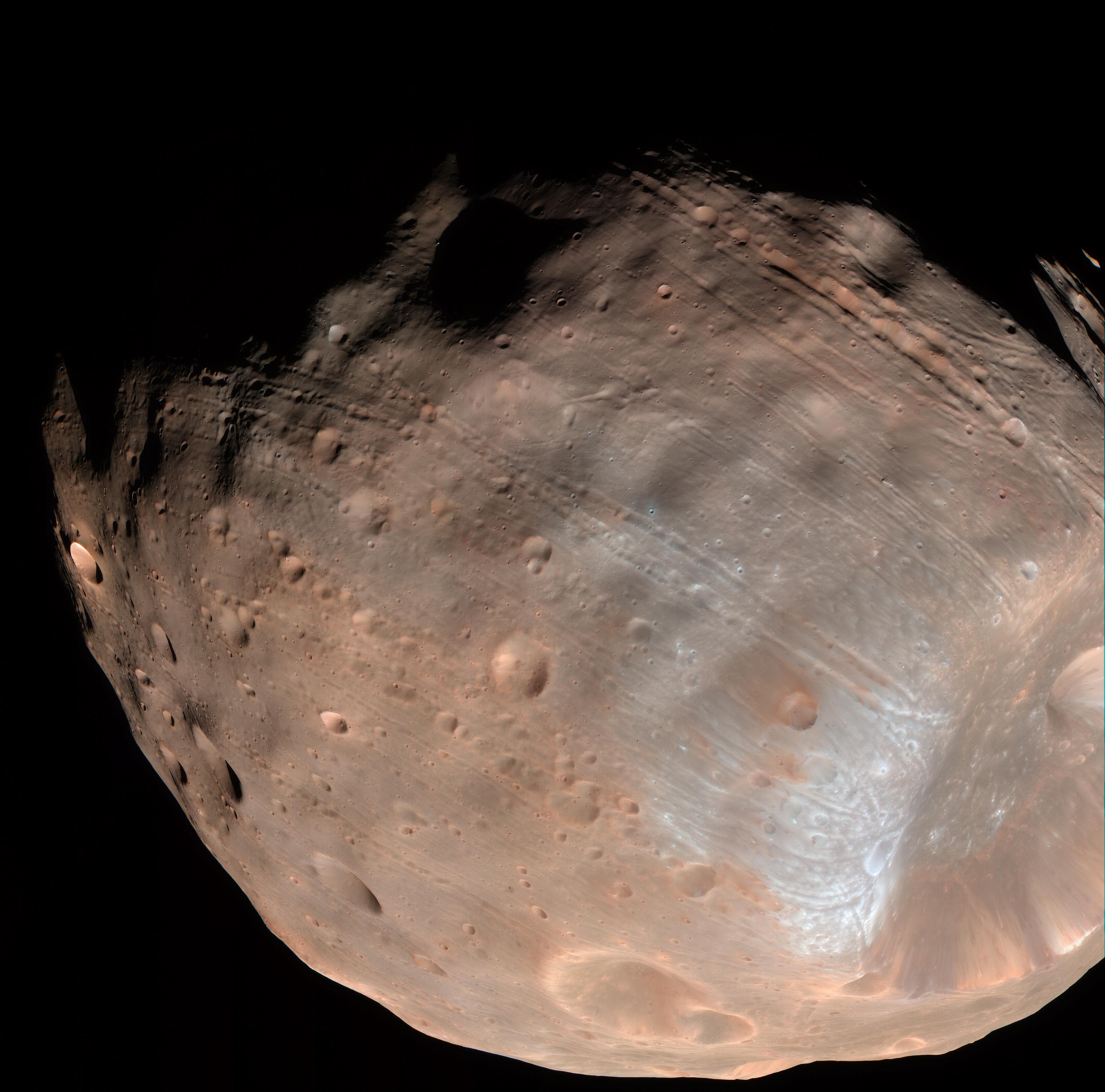 Another good view of both the grooves and the heavily cratered surface of Phobos. Image Credit: NASA/JPL-Caltech/University of Arizona