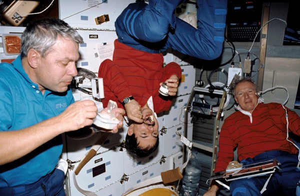 STS-35 crewmen (from left) Bob Parker, Ron Parise and Vance Brand share a meal on Columbia's middeck. Photo Credit: NASA, via Joachim Becker/SpaceFacts.de