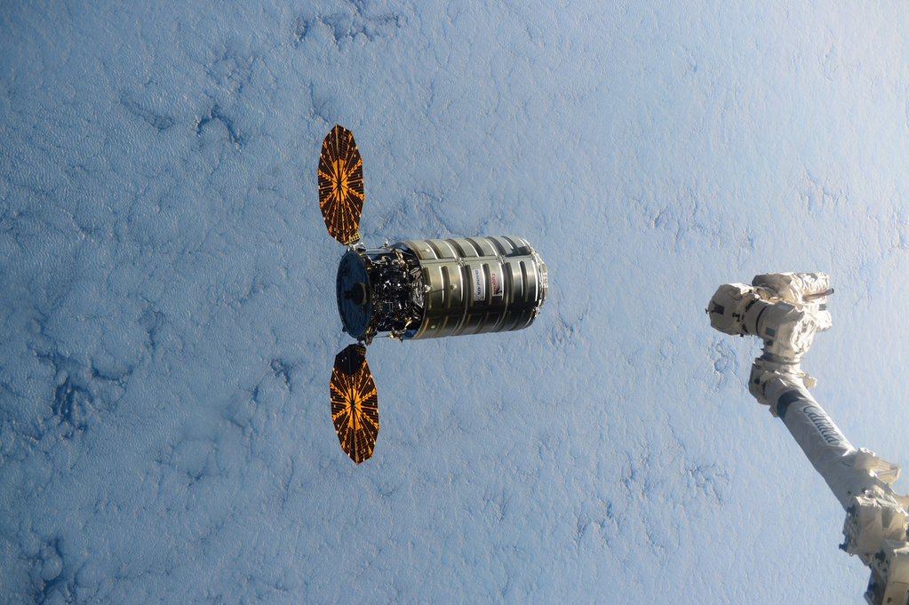 Proudly displaying its circular, fan-like UltraFlex solar arrays, the OA-4 Cygnus spacecraft is pictured shortly before being grappled by Canadarm2. Photo Credit: Scott Kelly/NASA/Twitter