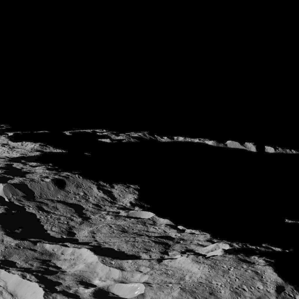 View of a region of Ceres in the southern hemisphere, with dramatic long shadows, at approximately 85.6 south longitude, 176.6 east longitude. Image credit: NASA/JPL-Caltech/UCLA/MPS/DLR/IDA
