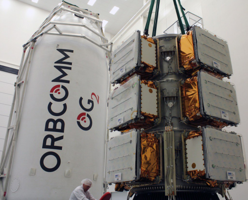 A fully-loaded trio of ESPA rings stand alongside the Falcon 9 payload fairing, prior to encapsulation. Photo Credit: Orbcomm