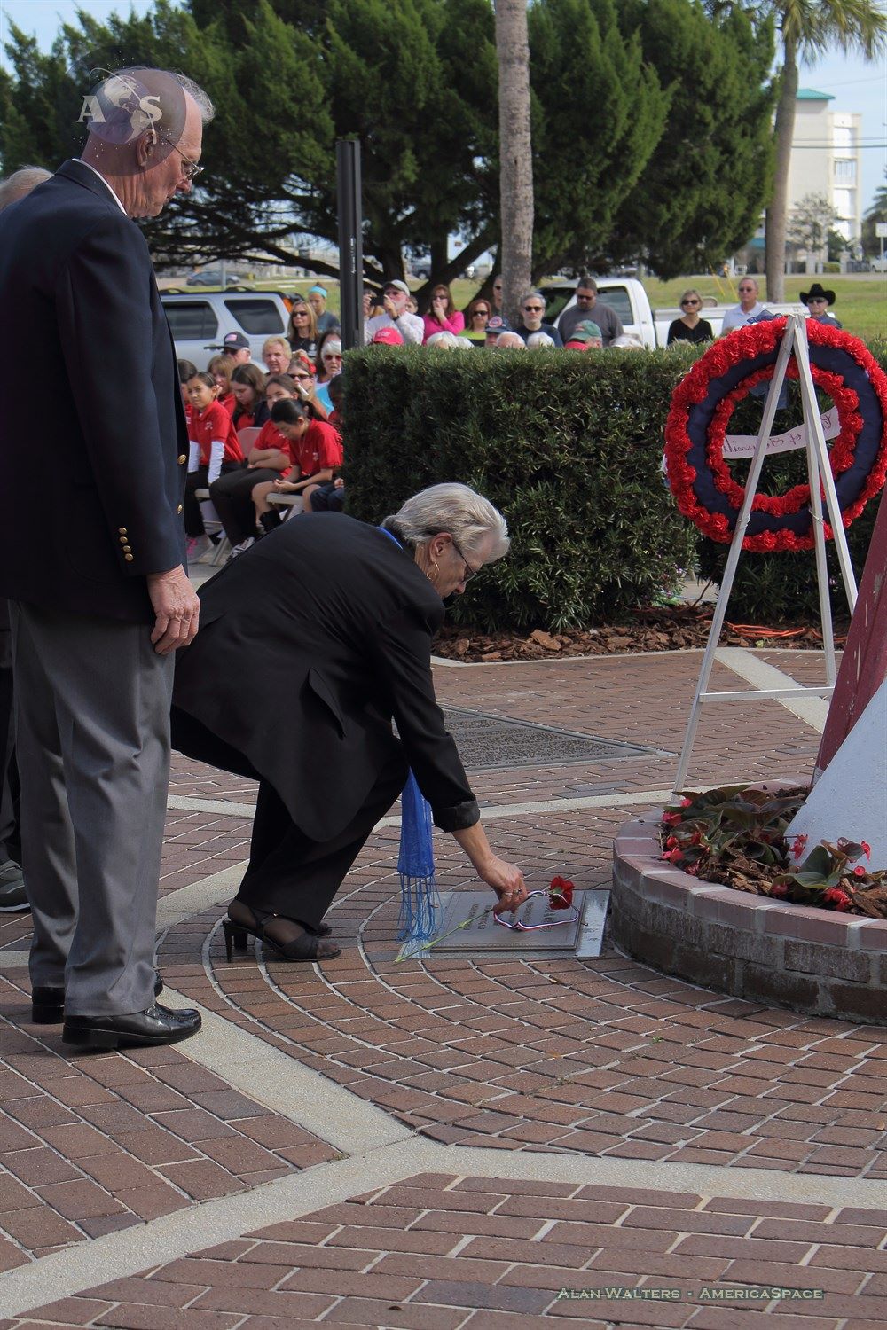A local member of the community places a flower on Roger B. Chaffee's plaque, who died in the Apollo 1 flash fire on Jan. 27, 1967. Photo Credit: Alan Walters / AmericaSpace