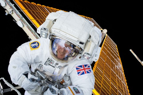 With the Union Jack gracing the sleeve of his Extravehicular Mobility Unit (EMU), Tim Peake grins for Tim Kopra's camera. Photo Credit: NASA