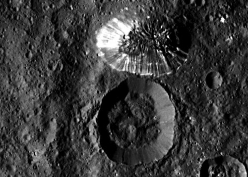 The “Lonely Mountain” which is about 4 miles (6 kilometers) tall, adjacent to a similar-sized crater. How did it form? Photo Credit: NASA/JPL-Caltech/UCLA/MPS/DLR/IDA