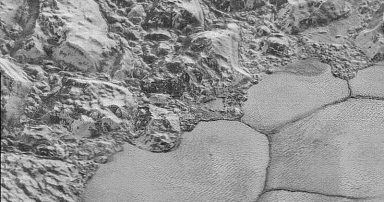 Mountains of solid water ice which border the smooth nitrogen ice plains, giving the appearance of a “shoreline.” On Pluto, water ice is as hard as rock. Photo Credit: NASA/JHUAPL/SwRI