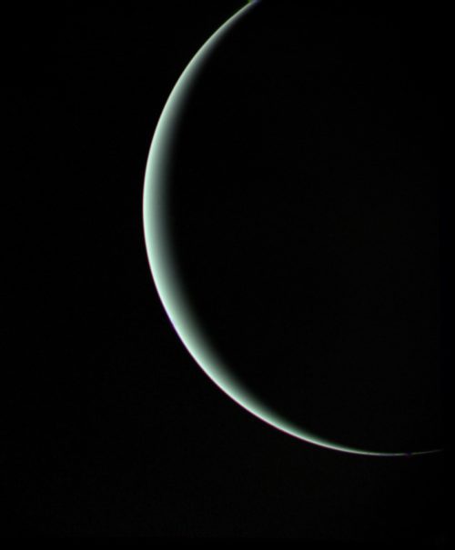 Visible only as a crescent, Uranus recedes from Voyager 2 in the days after Closest Approach. Photo Credit: NASA