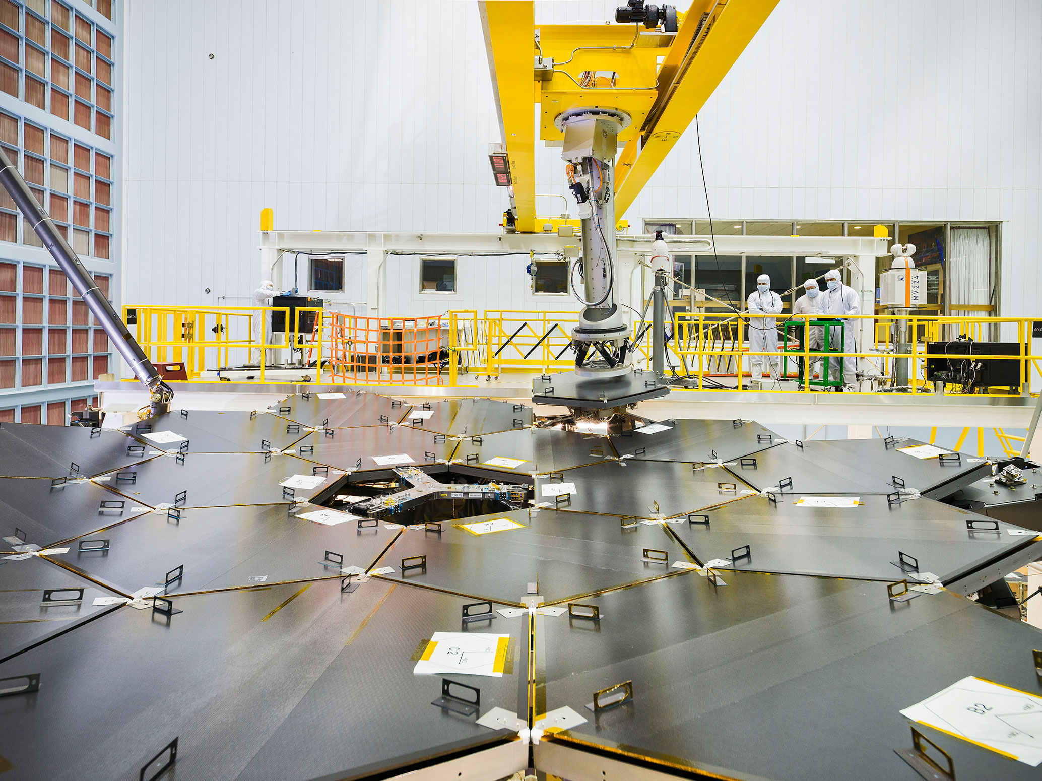 From NASA: "Inside a massive clean room at NASA's Goddard Space Flight Center in Greenbelt, Maryland the James Webb Space Telescope team used a robotic am to install the last of the telescope's 18 mirrors onto the telescope structure." NASA/Chris Gunn