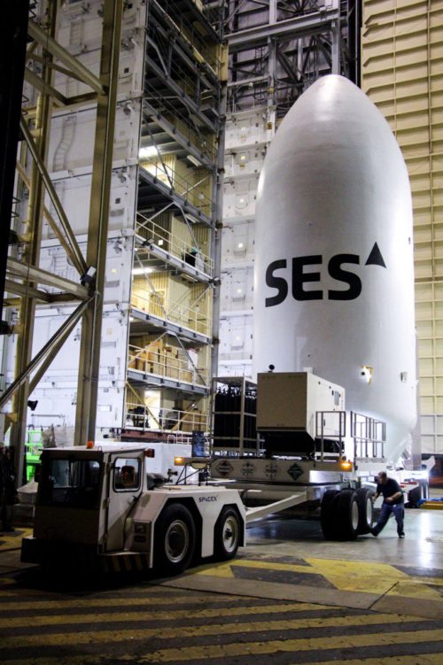 Encapsulated within its two-piece (or "bisector") Payload Fairing (PLF), the SES-9 satellite is readied for integration with the Upgraded Falcon 9 booster. Photo Credit: SES/Twitter