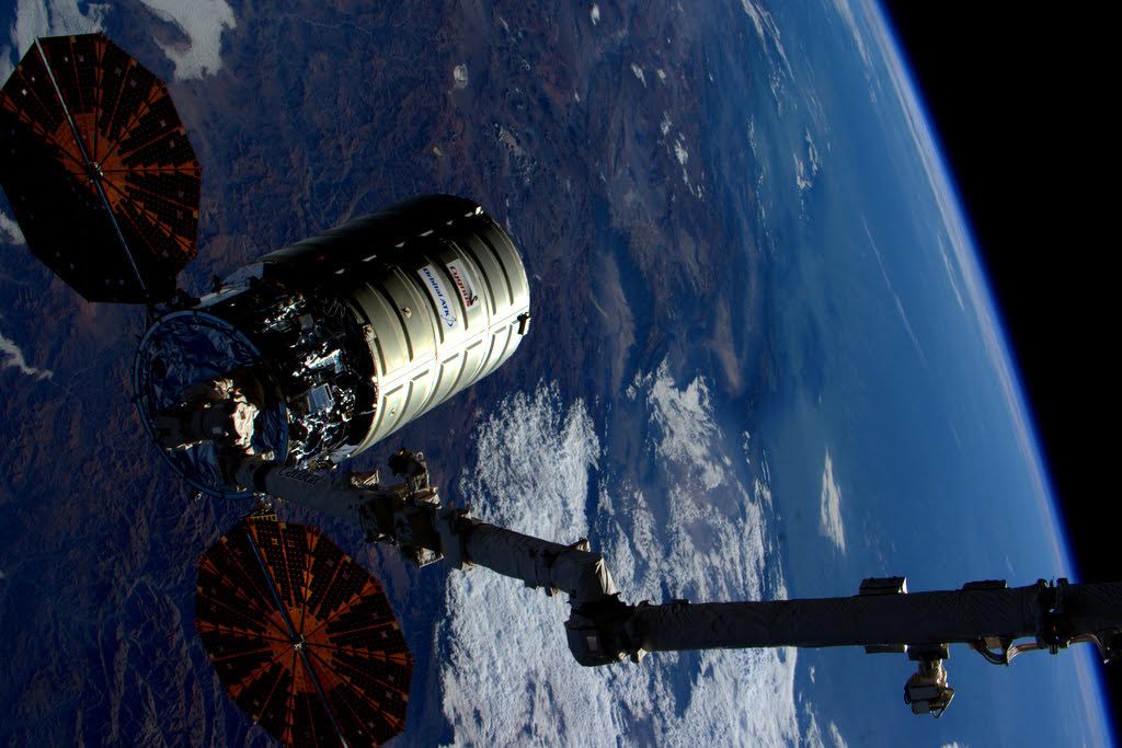 The OA-4 Cygnus spacecraft is pictured high above Bolivia, just prior to release by Canadarm2. Photo Credit: NASA/Scott Kelly/Twitter