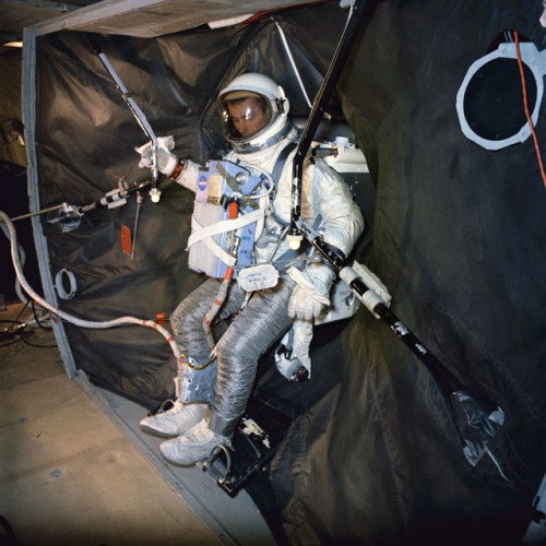 Gemini IX backup crewman Gene Cernan performs a suited evaluation with the Astronaut Maneuvering Unit (AMU). Photo Credit: NASA