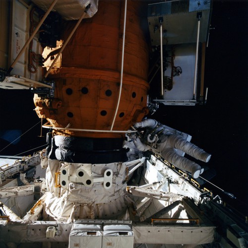 Rich Clifford works close to the orange-colored docking module in Atlantis' payload bay, during his EVA with Linda Godwin. Photo Credit: NASA, via Joachim Becker/SpaceFacts.de