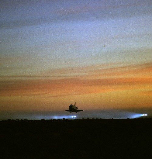 Like a bird of prey in the pre-dawn gloom, Atlantis heads for a touchdown at Edwards Air Force Base, Calif., on 31 March 1996. Photo Credit: NASA, via Joachim Becker/SpaceFacts.de
