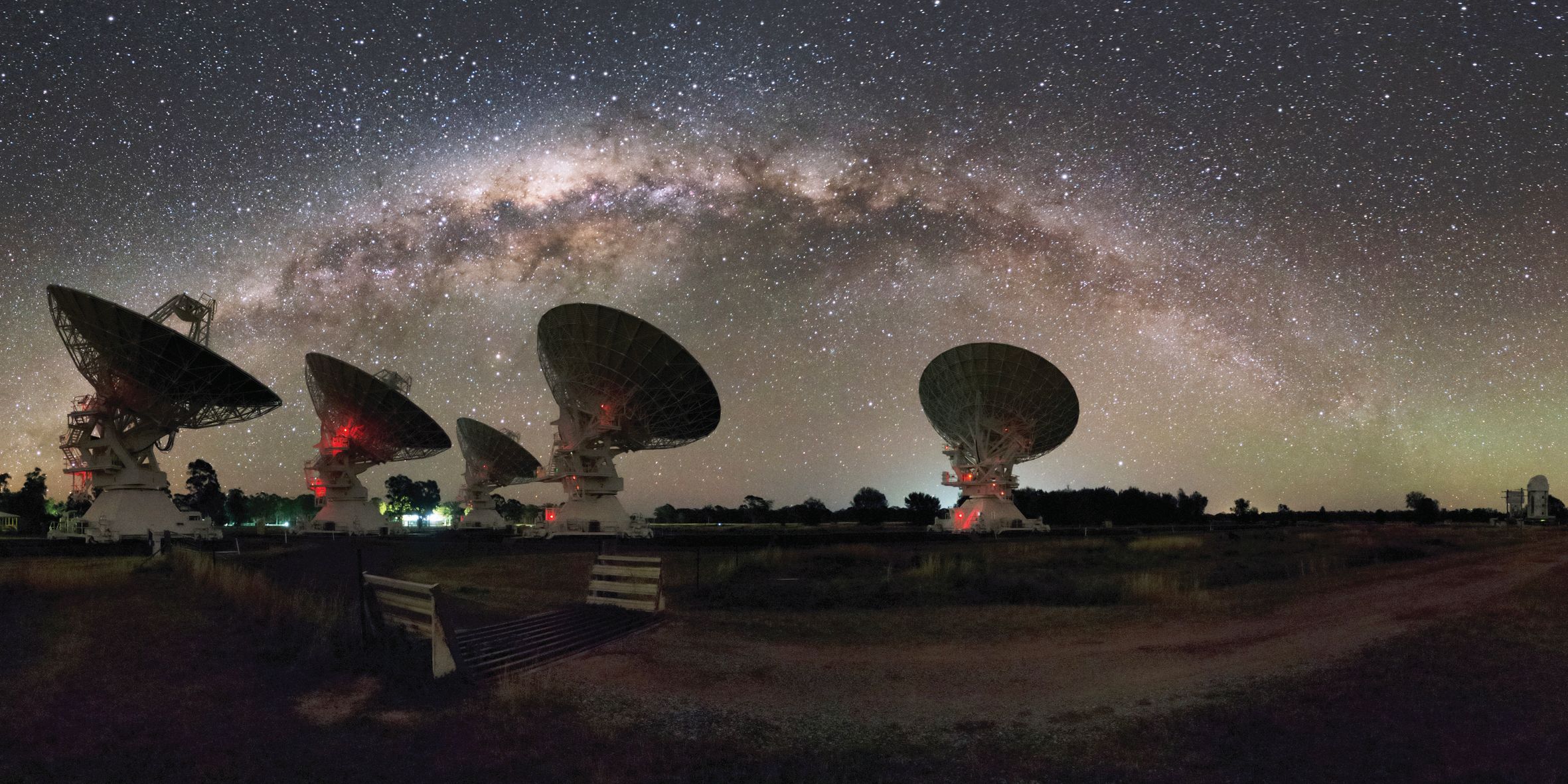 A composite image of the Milky Way above the Australia Telescope Compact Array, which has been utilised in the study of fast radio bursts in recent years. A series of recent discoveries, including the detection of the first-ever repeating fast radio burst, has added new layers to the existing mystery of this elusive cosmic phenomenon. Image Credit: Alex Cherney 