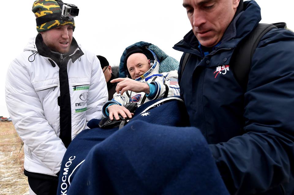 NASA Chief Astronaut Chris Cassidy (right) helps Scott Kelly away from the landing site. Photo Credit: Roscosmos