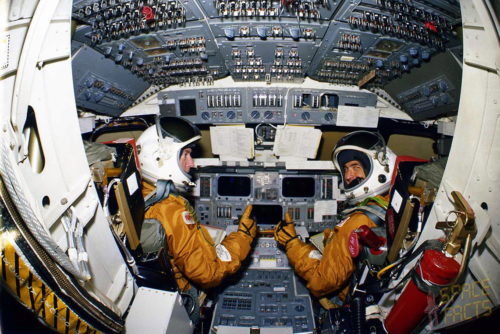 STS-1 Commander John Young (left) and Pilot Bob Crippen at their respective flight deck stations during training. Photo Credit: NASA, via Joachim Becker/SpaceFacts.de