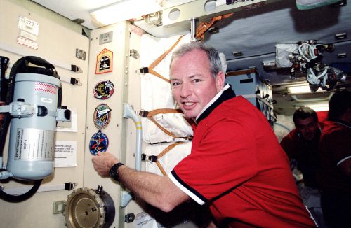 Brian Duffy adds the patch of STS-92, the 100th shuttle mission, to the wall of the International Space Station's Unity node in October 2000. Photo Credit: NASA