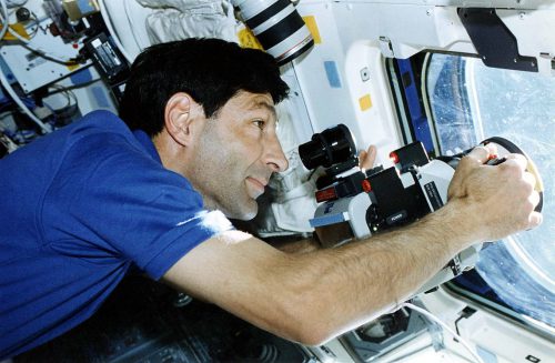Mario Runco works with camera equipment at Endeavour's flight deck windows. Photo Credit: NASA, via Joachim Becker/SpaceFacts.de