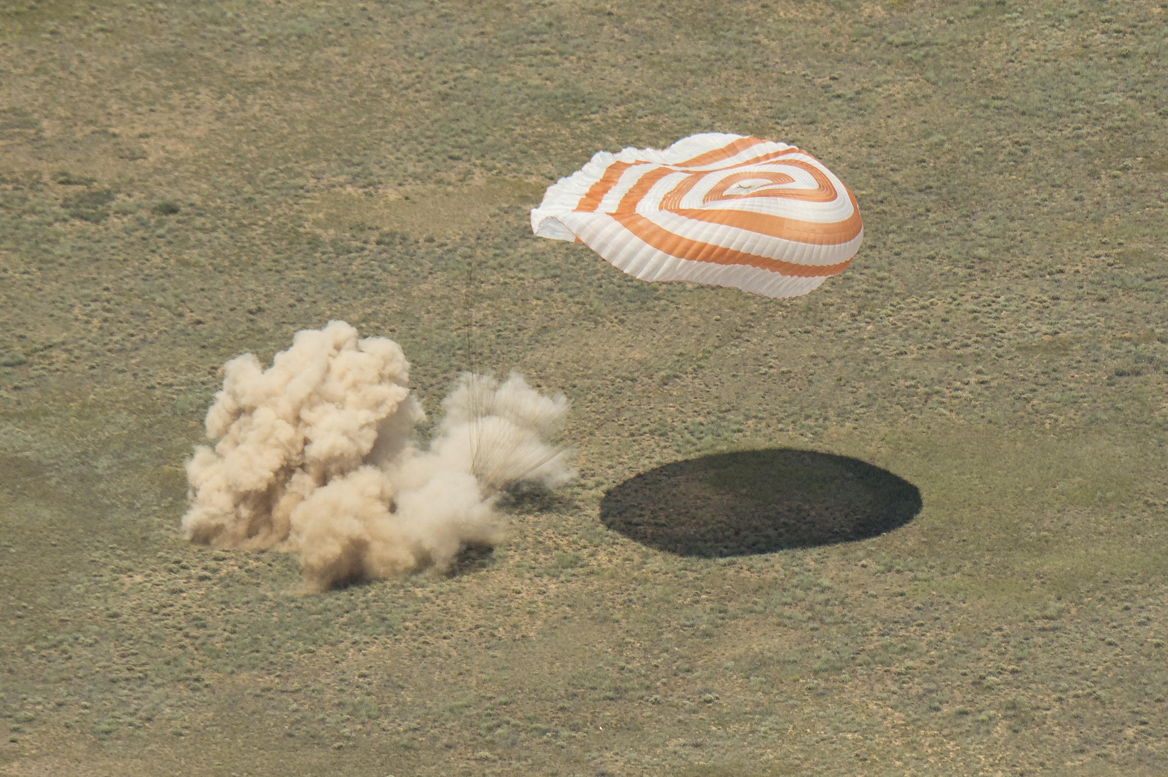 The Soyuz TMA-19M spacecraft is seen as it lands with Expedition 47 crew members Tim Kopra of NASA, Tim Peake of the European Space Agency, and Yuri Malenchenko of Roscosmos near the town of Zhezkazgan, Kazakhstan on Saturday, June 18, 2016. Kopra, Peake, and Malenchenko are returning after six months in space where they served as members of the Expedition 46 and 47 crews onboard the International Space Station. Photo Credit: NASA/Bill Ingalls