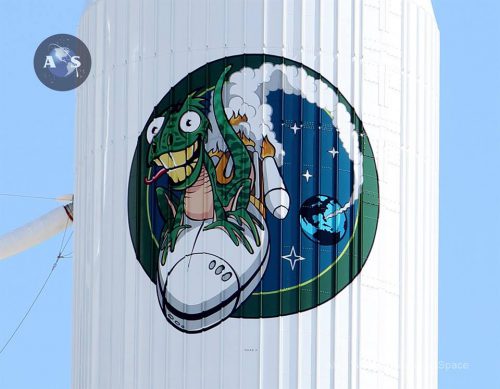 The NRO 61’s novel mission patch features a goofy looking green lizard dubbed “Spike by the NRO 61 development team riding piggyback on the Atlas V. With four stars honoring the government/industry team that developed the satellite and booster. Photo Credit: Alan Walters / AmericaSpace