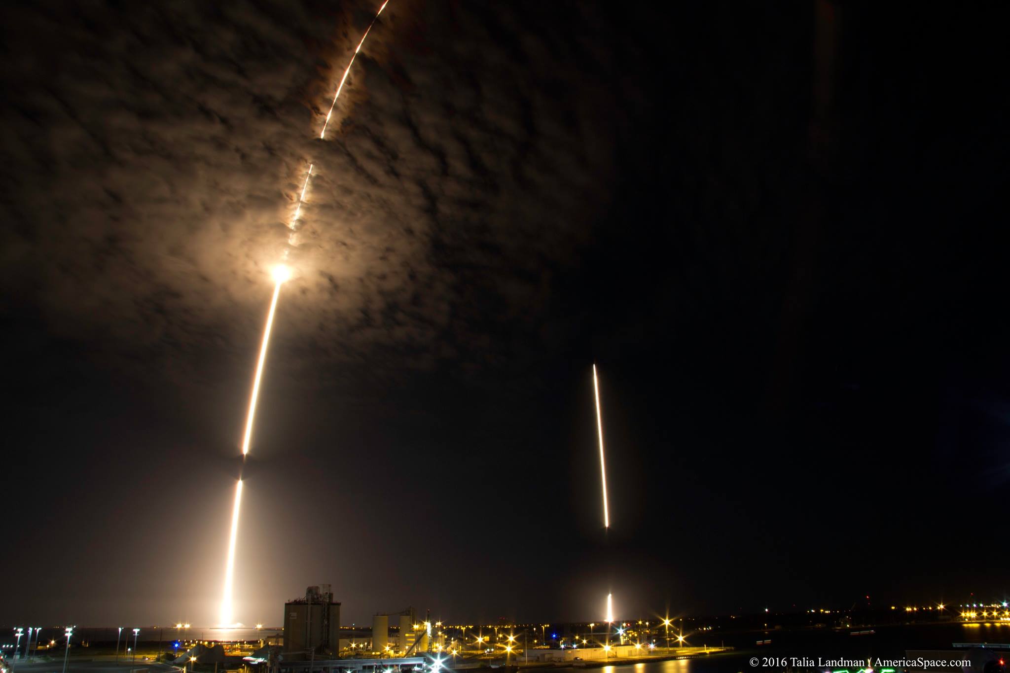 The Upgraded Falcon 9 launches into the night, and returns from the night, with its first-stage hardware alighting perfectly onto Landing Zone (LZ)-1 at the Cape. Photo Credit: Talia Landman / AmericaSpace