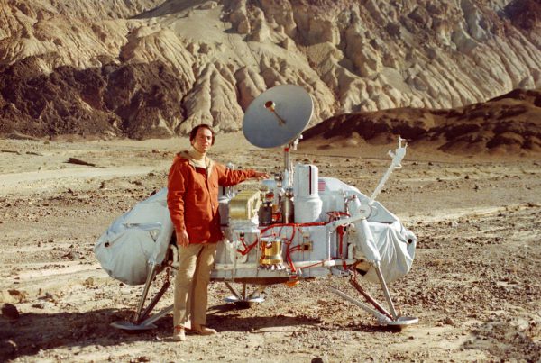 Carl Sagan posing with a model of the Viking 1 lander. Photo Credit: NASA