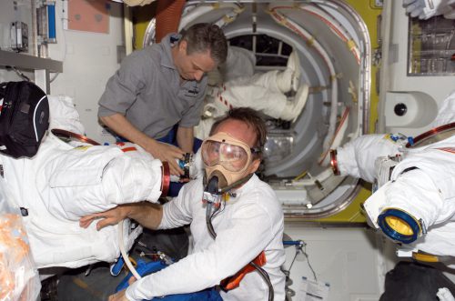 Assisted by Expedition 13's Thomas Reiter, STS-115 Mission Specialist Steve MacLean pre-breathes on a mask inside the Quest airlock, ahead of EVA-2. Photo Credit: NASA