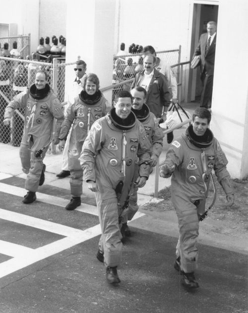 John Blaha (front right) and Mike Baker lead the STS-43 crew out of the Operations & Checkout (O&C) Building at 7:50 a.m. EDT on 2 August 1991. Photo Credit: NASA, via Joachim Becker/SpaceFacts.de
