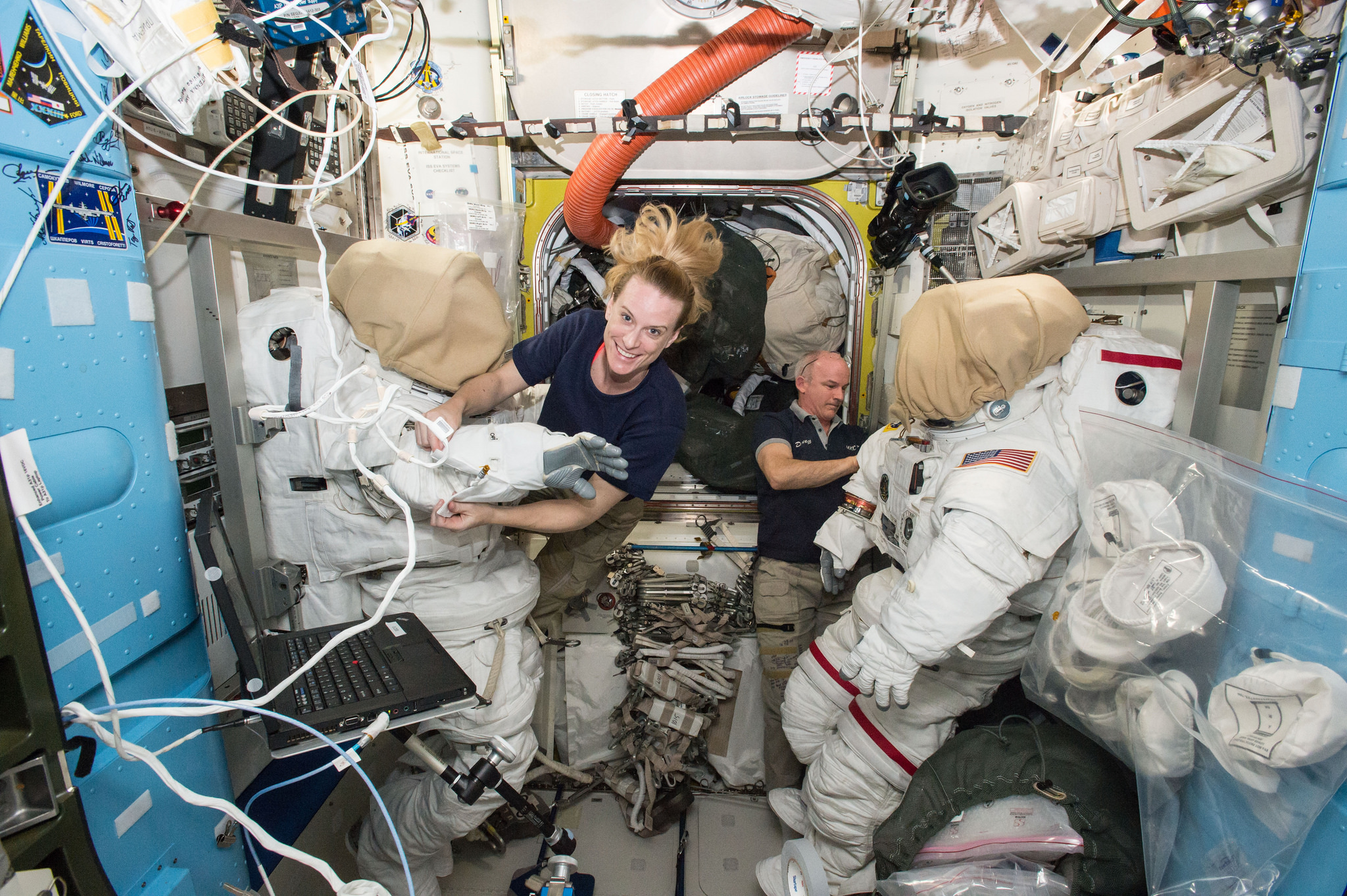 Expedition 48 Commander Jeff Williams and Flight Engineer Kate Rubins work with their Extravehicular Mobility Unit (EMU) suits in the Quest airlock. Photo Credit: NASA