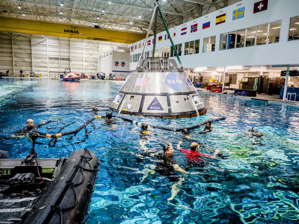 From NASA: "A group of U.S. Navy divers, Air Force pararescuemen and Coast Guard rescue swimmers practice Orion underway recovery techniques in the Neutral Buoyancy Laboratory at NASA’s Johnson Space Center in Houston on Sept. 21, 2016." Photo Credit: NASA/Radislav Sinyak