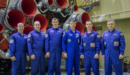 The prime and backup crews for Soyuz MS-02 pose at the "business end" of their Soyuz-FG booster. From left are backup crew members Mark Vande Hei, Aleksandr Misurkin and Nikolai Tikhonov and prime crew members Shane Kimbrough, Sergei Ryzhikov and Andrei Borisenko. Photo Credit: NASA