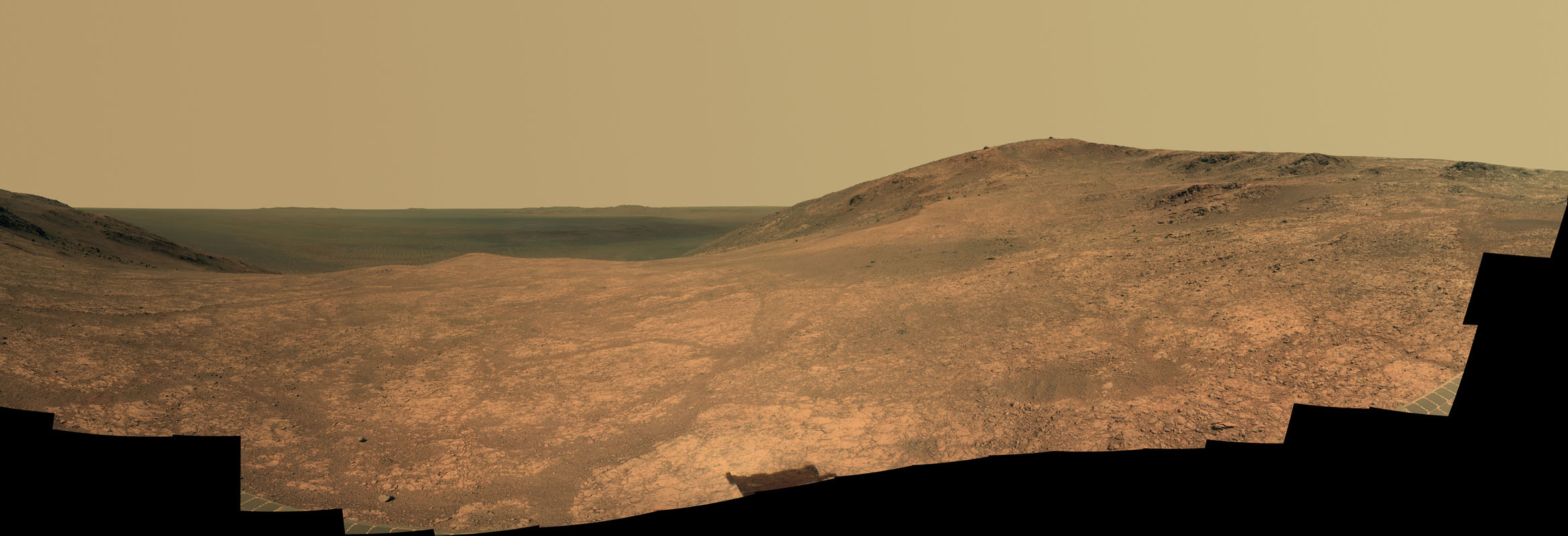 Panoramic view of Marathon Valley as seen by the Opportunity rover. The interior of Endeavour Crater lies in the distance. Soon, the rover will move southward to examine a gully thought to have been carved by water long ago. Photo Credit: NASA/JPL-Caltech/Cornell Univ./Arizona State Univ.