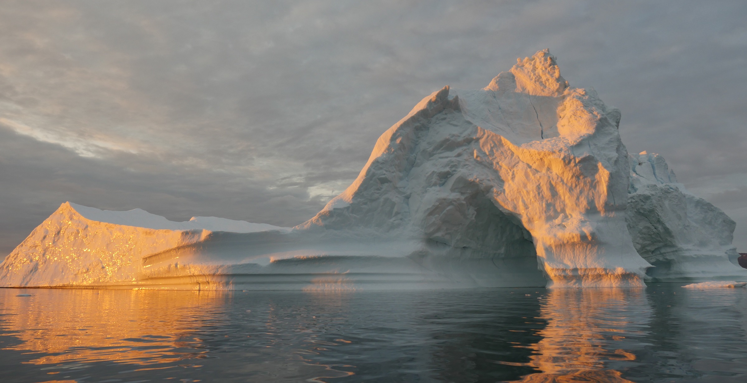 An iceberg floats in Disko Bay, near Ilulissat, Greenland, on July 24, 2015. The massive Greenland ice sheet is shedding about 300 gigatons of ice a year into the ocean, making it the single largest source of sea level rise from melting ice. Credits: NASA/Saskia Madlener