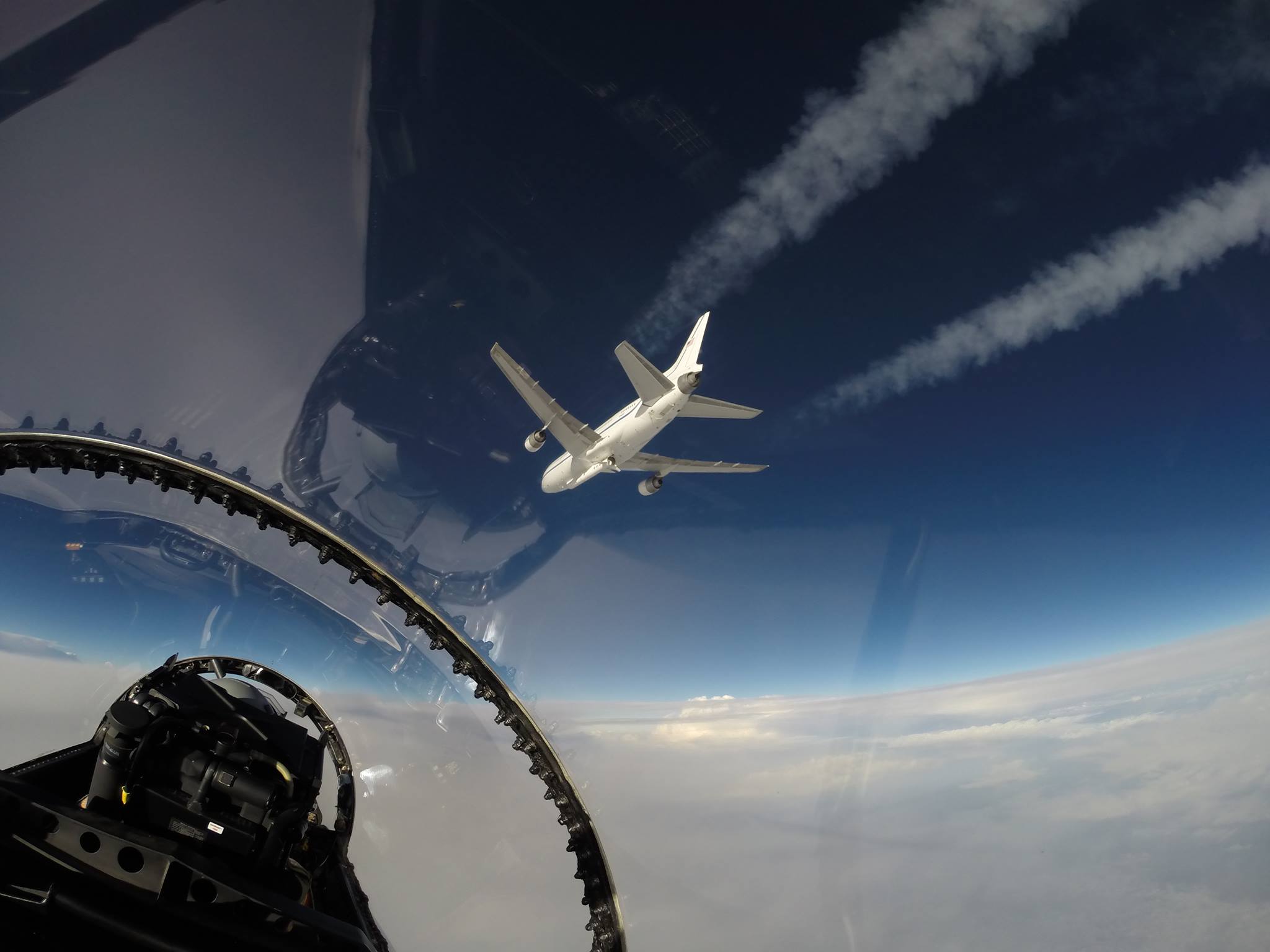 The view of Orbital ATK's L-1011 Stargazer and Pegasus XL rocket (underneath), as seen from the F-18 jet used to provide live coverage of the launch carrying NASA's Cyclone Global Navigation Satellite System (CYGNSS). Flying the F-18 was NASA Test Pilot Troy Asher, with NASA Videographer Lori Losey backseat. Photo Credit: NASA / Lori Losey